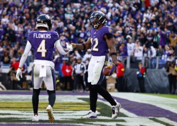 Baltimore Ravens running back Derrick Henry (22) and wide receiver Zay Flowers (4) celebrate a touchdown.