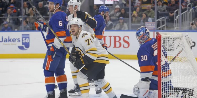 Viktor Arvidsson (71) celebrates Pavel Zacha's power play goal during the Bruins shootout win over the Islanders.