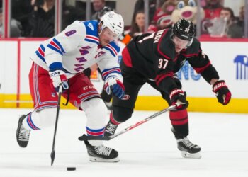 J.T. Miller skates with the puck past Andrei Svechnikov during the second period of the Rangers' 4-2 road win over the Hurricanes on Nov. 26, 2025.