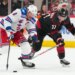 J.T. Miller skates with the puck past Andrei Svechnikov during the second period of the Rangers' 4-2 road win over the Hurricanes on Nov. 26, 2025.