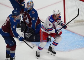 New York Rangers center J.T. Miller reacts after scoring a goal past Colorado Avalanche goaltender Scott Wedgewood as defenseman Cale Makar looks on.
