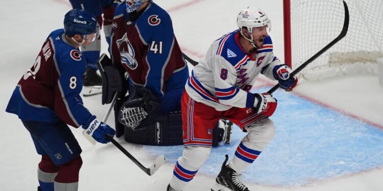 New York Rangers center J.T. Miller reacts after scoring a goal past Colorado Avalanche goaltender Scott Wedgewood as defenseman Cale Makar looks on.