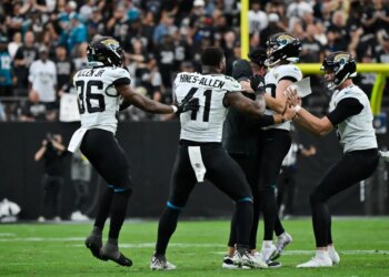Jacksonville Jaguars' Cam Little is congratulated by coach Liam Coen and teammates after making a 68-yard field goal.