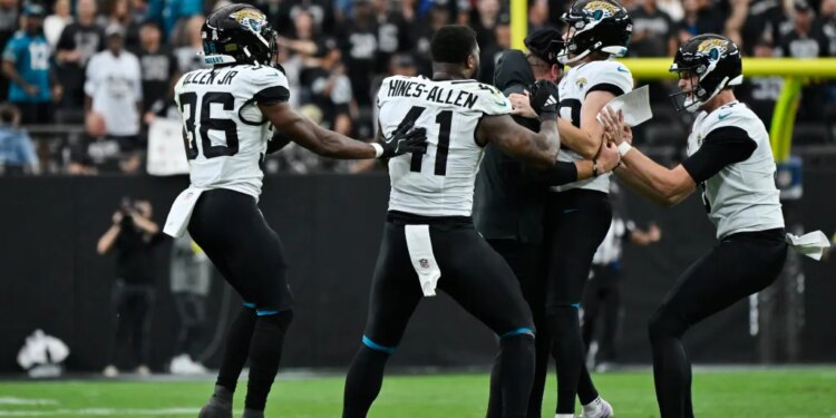 Jacksonville Jaguars' Cam Little is congratulated by coach Liam Coen and teammates after making a 68-yard field goal.
