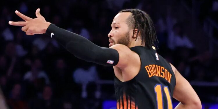 Jalen Brunson #11 of the New York Knicks reacts after hitting a three-point shot.