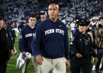 Penn State head coach James Franklin walks off the field with security after the game against Northwestern.