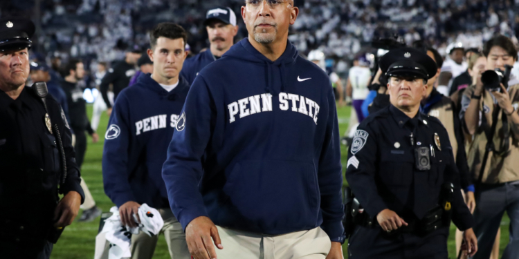Penn State head coach James Franklin walks off the field with security after the game against Northwestern.