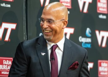 James Franklin, Virginia Tech's new head football coach, smiles during a news conference.