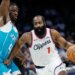 Los Angeles Clippers guard James Harden drives to the basket against Charlotte Hornets guard Sion James.
