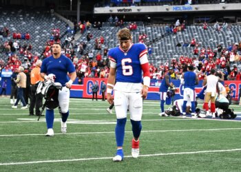 Giants quarterback Jaxson Dart (6) walking off the field after losing a football game.