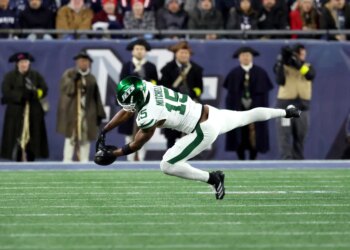 Adonai Mitchell #15 of the New York Jets fails to complete a reception for third down during the second quarter against the Patriots.