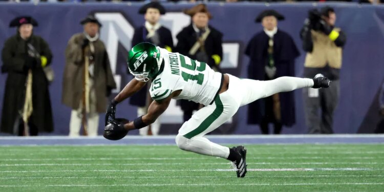 Adonai Mitchell #15 of the New York Jets fails to complete a reception for third down during the second quarter against the Patriots.
