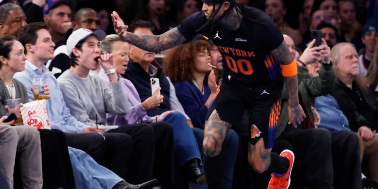 New York Knicks guard Jordan Clarkson interacts with fans during a game.