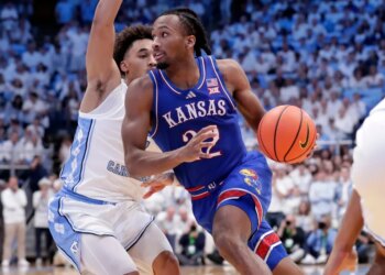 Kansas guard Darryn Peterson, right, drives against North Carolina guard Seth Trimble.