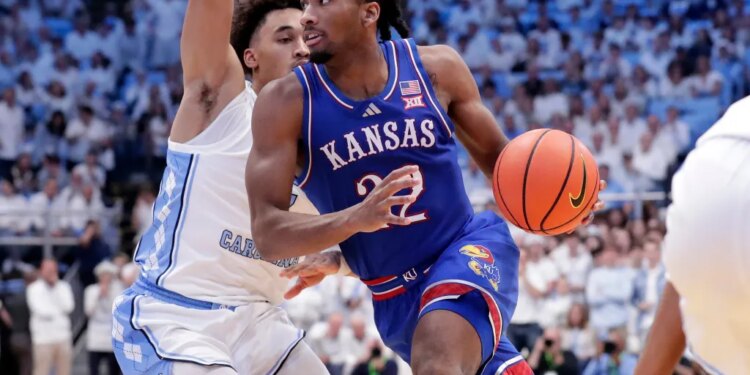 Kansas guard Darryn Peterson, right, drives against North Carolina guard Seth Trimble.