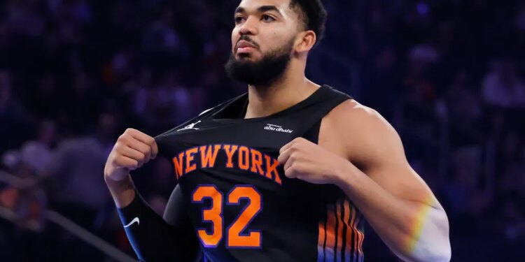 NBA player Karl-Anthony Towns stretches his jersey during a game.