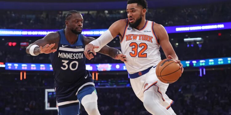 New York Knicks center Karl-Anthony Towns drives to the basket as Timberwolves Julius Randle defends.
