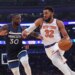 New York Knicks center Karl-Anthony Towns drives to the basket as Timberwolves Julius Randle defends.