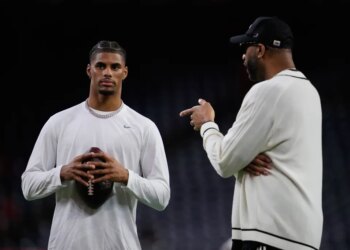 Buffalo Bills wide receiver Keon Coleman, left, talks with Tracy McGrady, right, during warmups before an NFL football game against the Houston Texans Thursday, November 20, 2025, in Houston.