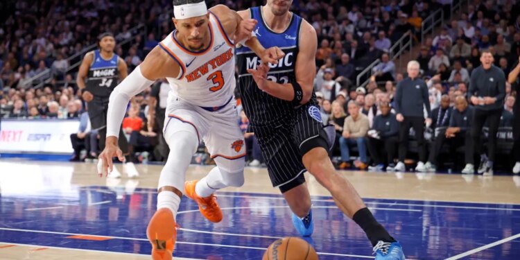 New York Knicks guard Josh Hart and Orlando Magic forward Franz Wagner chase a loose ball in the second half at Madison Square Garden in New York, New York, November 12, 2025.