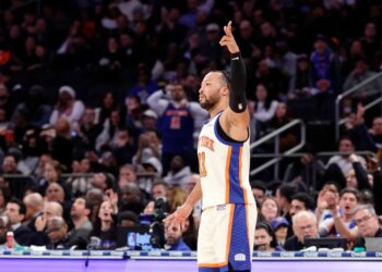Jalen Brunson #11 of the New York Knicks reacts after hitting a three-point shot during the second half.