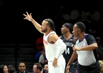 Jalen Brunson #11 of the New York Knicks reacts after hitting a 3-point shot during the first quarter.