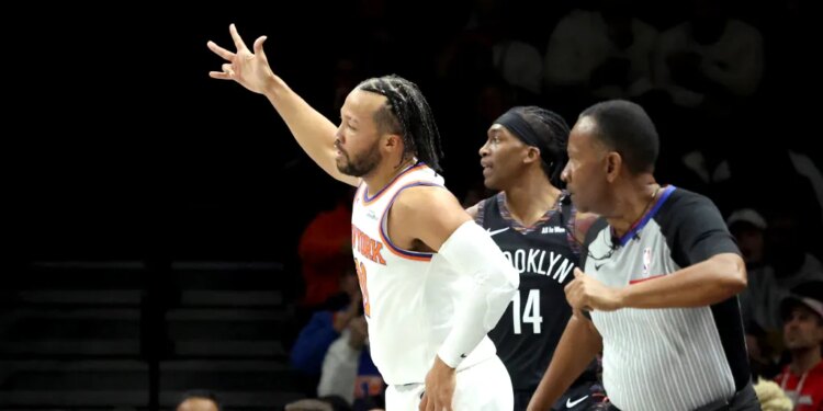 Jalen Brunson #11 of the New York Knicks reacts after hitting a 3-point shot during the first quarter.