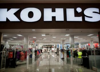 The entrance to a Kohl's department store, with clothing racks visible inside.