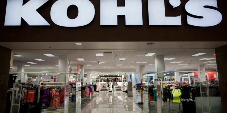 The entrance to a Kohl's department store, with clothing racks visible inside.