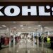 The entrance to a Kohl's department store, with clothing racks visible inside.