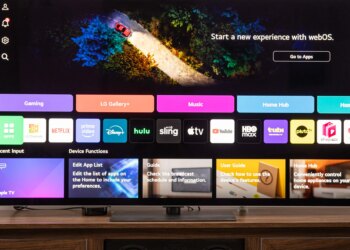 The LG G5 OLED TV on a wooden home theater cedenza display the webOS home screen.