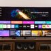 The LG G5 OLED TV on a wooden home theater cedenza display the webOS home screen.