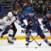 Colorado Avalanche center Brock Nelson (11) heads down the ice with the puck as center Ross Colton, back right, and Tampa Bay Lightning center Dominic James pursue in an NHL hockey game.