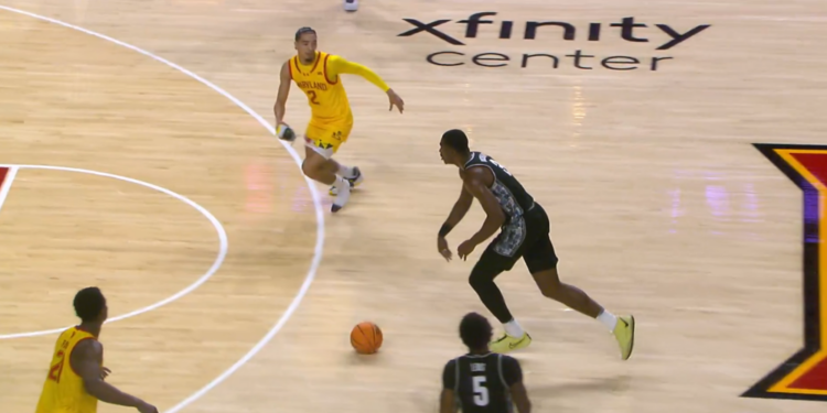 Myles Rice, with his right shoe in hand, runs towards Georgetown's Vince Iwuchukwu to try to cause a defensive stop or steal on Friday night.