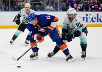 New York Islanders' Mathew Barzal (13) drives past Seattle Kraken's Matty Beniers