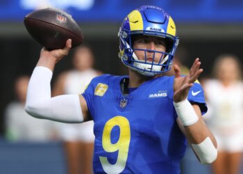 Matthew Stafford of the Los Angeles Rams in uniform holding a football.