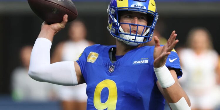 Matthew Stafford of the Los Angeles Rams in uniform holding a football.