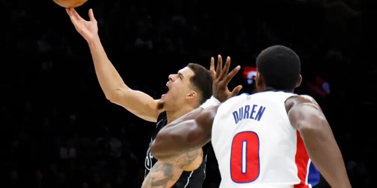 Brooklyn Nets forward Michael Porter Jr. puts up a shot past a defending Detroit Pistons center Jalen Duren (R) in the first half at the Barclays Center in Brooklyn, New York, November 07, 2025.