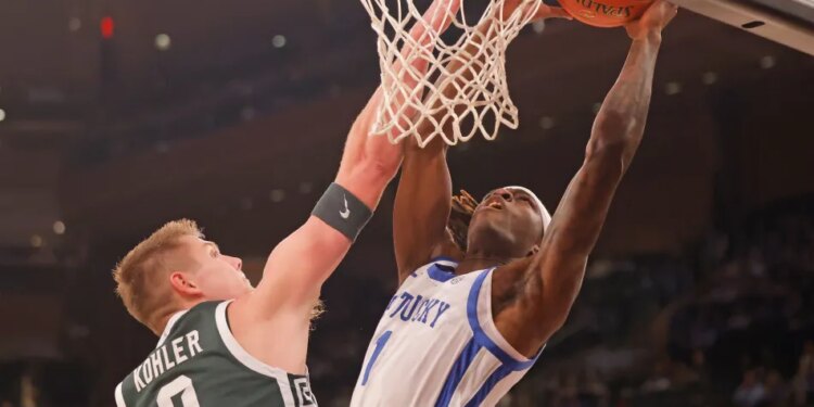 Michigan State Spartans forward Jaxon Kohler (0) stops Kentucky Wildcats guard Denzel Aberdeen (1) at the basket during the first half when the Kentucky Wildcats played the Michigan State Spartans as part of the State Farm Champions Classic Tuesday, November 18, 2025.