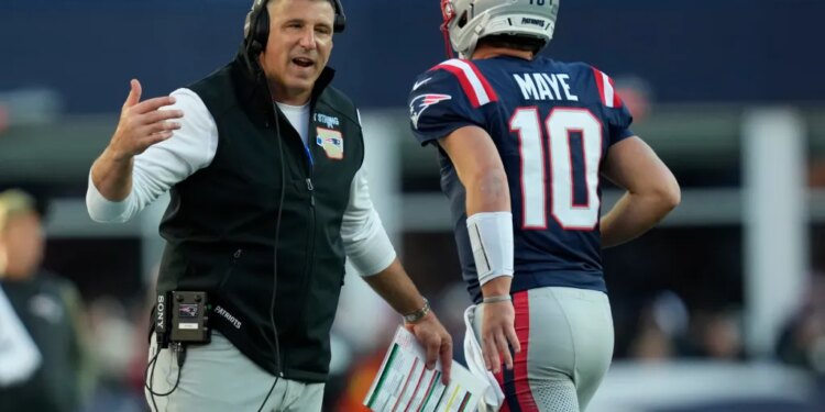 Patriots coach Mike Vrabel with quarterback Drake Maye during the team's Week 9 win over the Falcons.