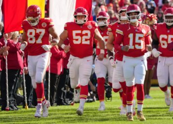 Kansas City Chiefs players running onto the field.