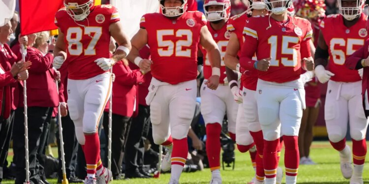 Kansas City Chiefs players running onto the field.