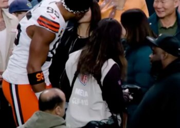 Browns defensive end Myles Garrett and Olympic snowboarder Chloe Kim on the sideline before Cleveland's game against the Raiders at Allegiant Stadium on November 23, 2025.