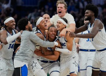 Orlando Magic guard Desmond Bane, center, celebrates with teammates after making a game winning shot against the Portland Trail Blazers.