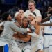 Orlando Magic guard Desmond Bane, center, celebrates with teammates after making a game winning shot against the Portland Trail Blazers.