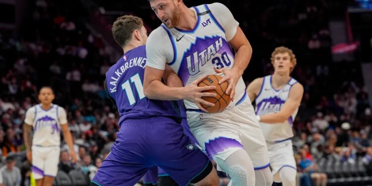 Utah Jazz center Jusuf Nurkic (30) with the ball trying to elude Charlotte Hornets center Ryan Kalkbrenner (11) during the second half at Spectrum Center.