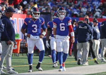 Russell Wilson #3 of the New York Giants and Jaxson Dart #6 of the New York Giants on the sideline.