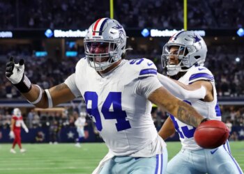 Marshawn Kneeland celebrating with Malik Davis after recovering a blocked punt for a touchdown.