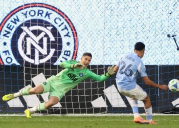 Charlotte FC goalkeeper Kristijan Kahlina (1) dives to save a shot by New York City forward Agustín Ojeda (26) during a shootout during Game 2 in the first round of MLS soccer's Eastern Conference playoffs Saturday, Nov. 1, 2025.
