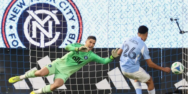 Charlotte FC goalkeeper Kristijan Kahlina (1) dives to save a shot by New York City forward Agustín Ojeda (26) during a shootout during Game 2 in the first round of MLS soccer's Eastern Conference playoffs Saturday, Nov. 1, 2025.